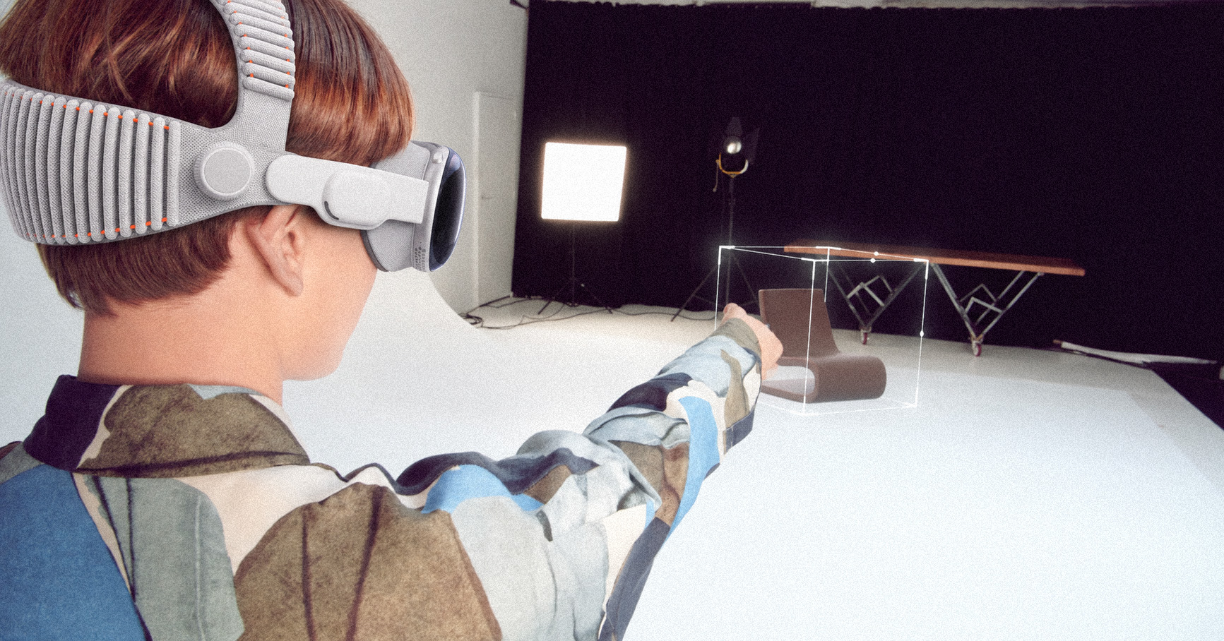 A person wearing Apple Vision Pro previews a chair in the room.